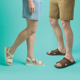 Lady wearing white sandals and man wearing brown sandals